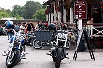 Motorbikes parked in front of Bisley Pavilion